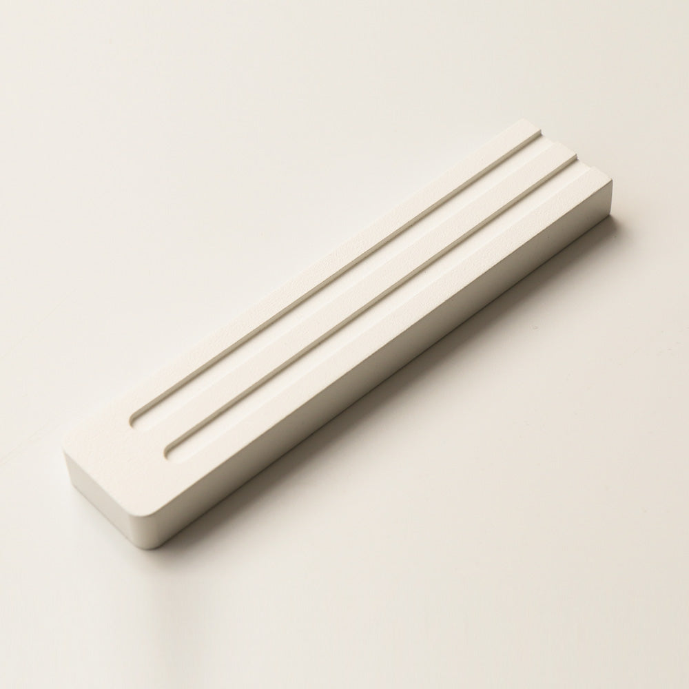 A sleek and refined mezuzah by JUDA that blends modern design with Jewish tradition. Crafted from aluminum using CNC machining and electrostatic painting, it features two clean lines that subtly form the letter Shin (ש). Available in two sizes. A meaningful and aesthetic addition to any doorway.