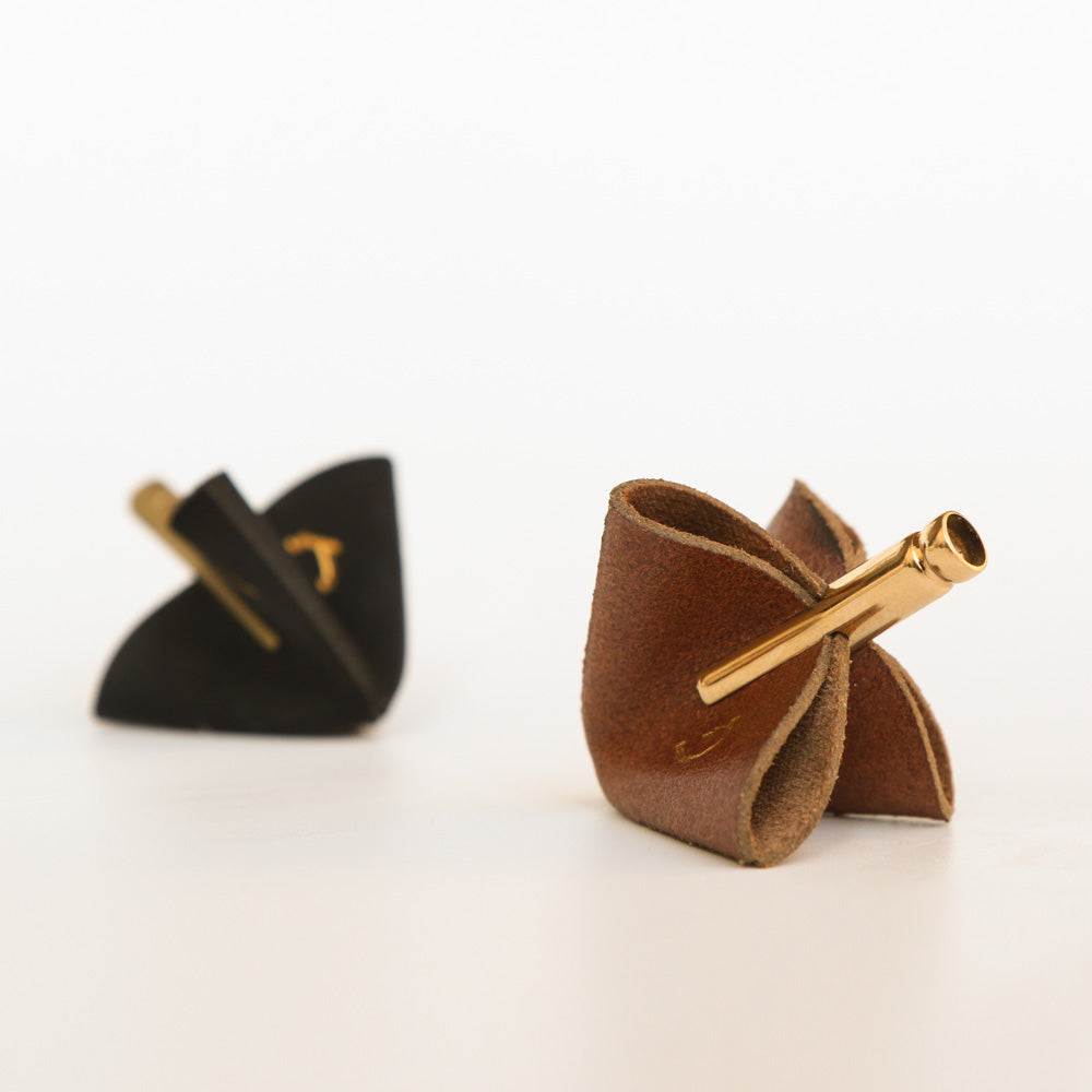 Discover the JUDA Leather Dreidel – a unique Hanukkah piece crafted from genuine leather and brass. Inspired by traditional bookbinding and kippah making, its f…